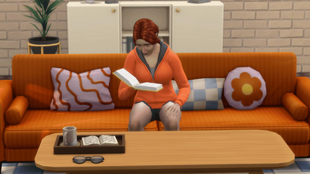 A screenshot from The Sims 4 showing a sim sitting on an orange couch reading a book