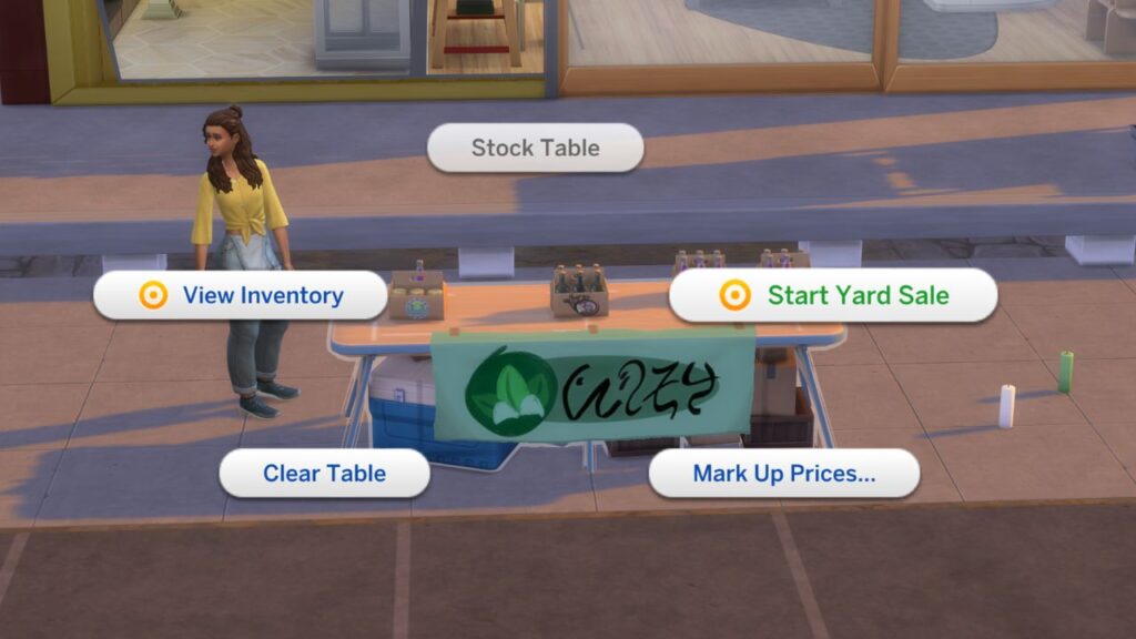 A sim standing behind a market table with Start Yard Sale highlighted