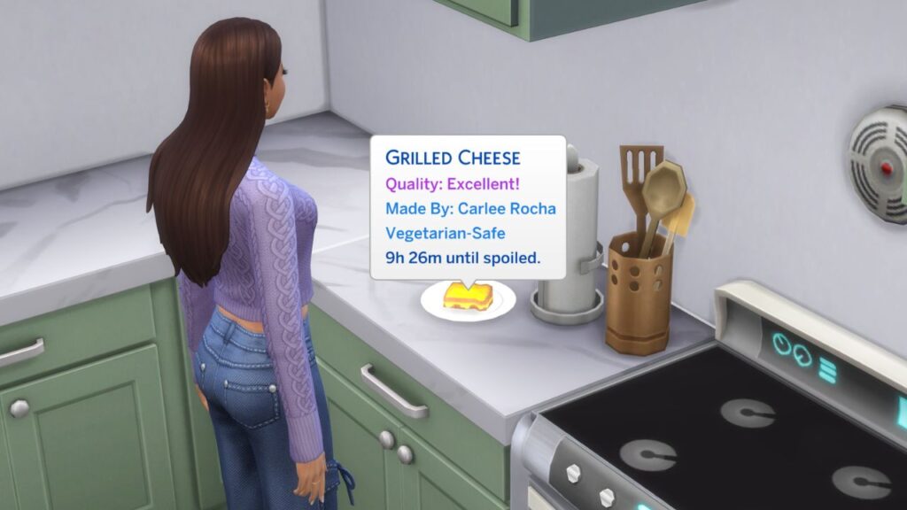 A screenshot from The Sims 4 showing a sim standing in front of a counter. On the counter is an excellent quality grilled cheese