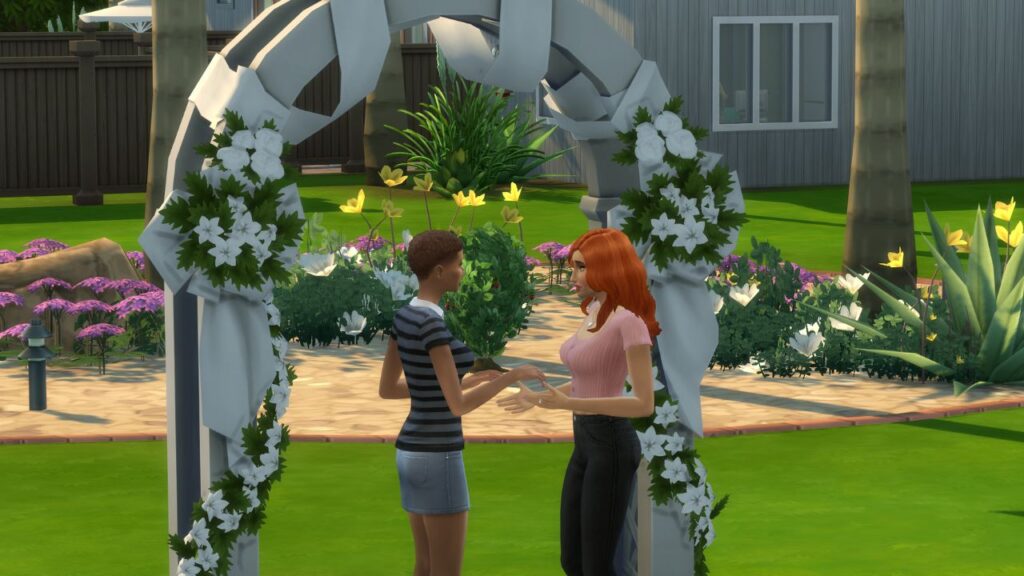 A screenshot from The Sims 4 of two sims getting married at a wedding arch