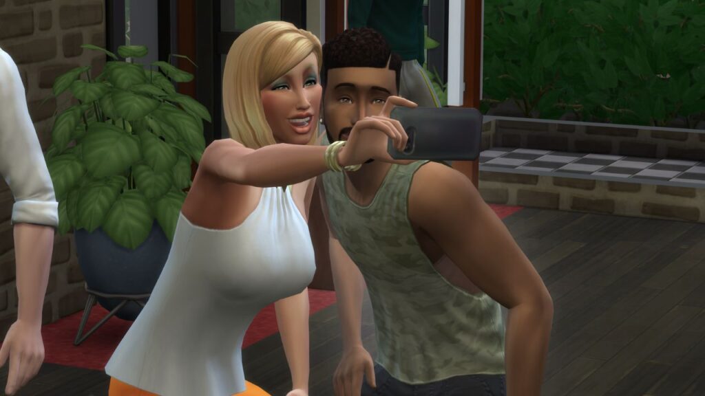 A screenshot from The Sims 4 showing a sim taking a selfie with Nancy Landgraab 