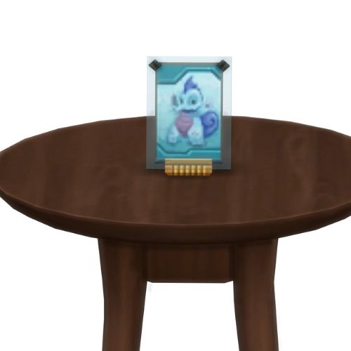 A screenshot from The Sims 4 showing a brown table with a Voidcritter on top. This has the voidcritter named pleuro