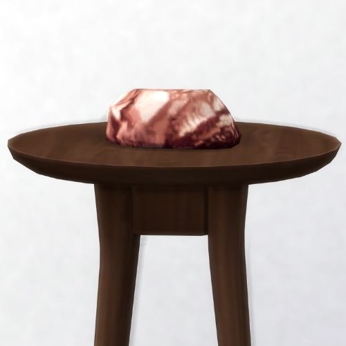 A screenshot from The Sims 4 showing a brown wooden table with romantium on top