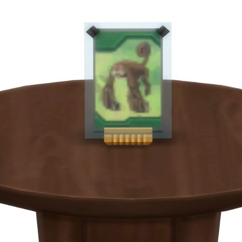A screenshot from The Sims 4 showing a brown table with a Voidcritter on top. This has the voidcritter named simgaia
