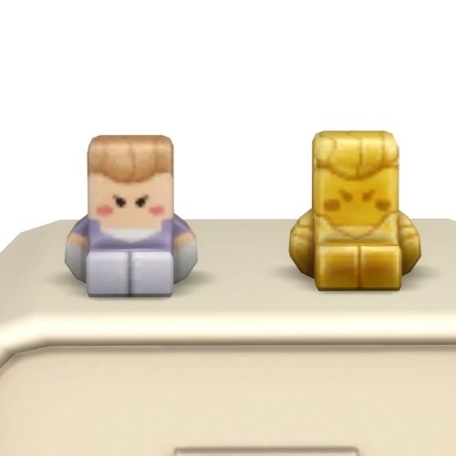A screenshot from the sims 4 the top of a table with two Simmies on top. The one is gold and the other is a regular Princess Cordelia Simmi