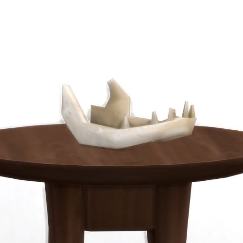 A screenshot from The Sims 4 showing a brown wood table and on top is a jaw bone from a cow plant