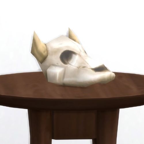 A screenshot from The Sims 4 showing a brown wood table and on top is the skull of a cowplant
