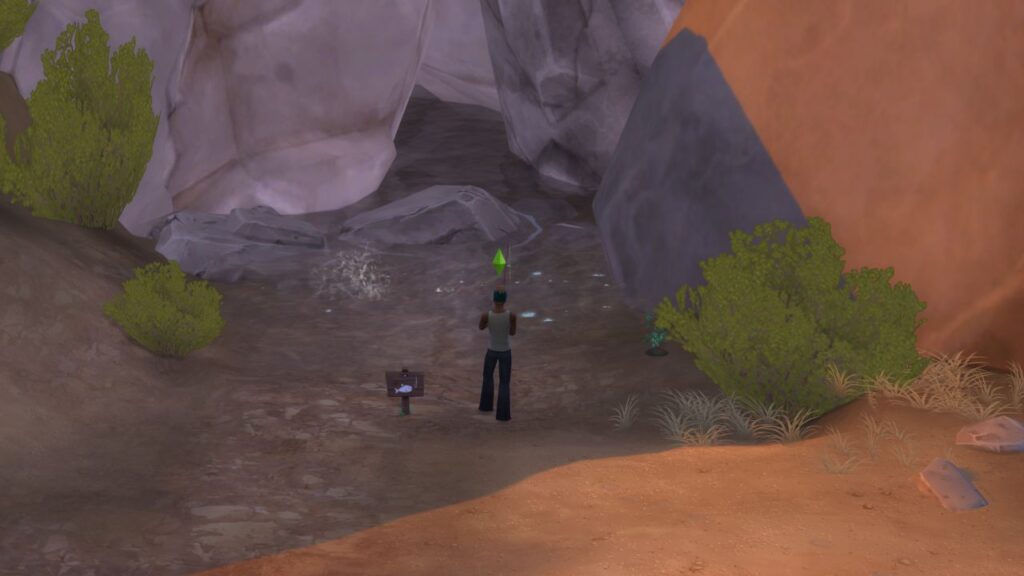 A screenshot from The Sims 4 showing the location of a fishing spot located at the back of the desert bloom park between two rocks