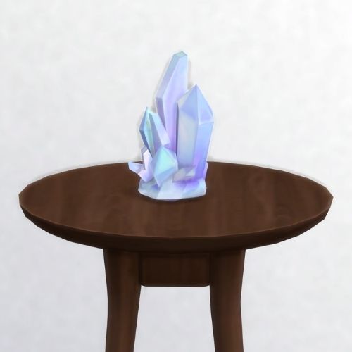 A screenshot from The Sims 4 showing a brown circular table with a crystal on top. This image has a crystal called diamond