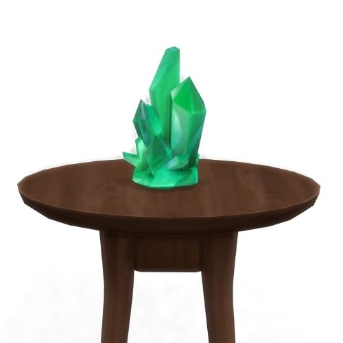 A screenshot from The Sims 4 showing a brown circular table with a crystal on top. This image has a crystal called emerald