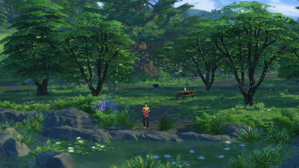 A screenshot from The Sims 4 showing a fishing spot in Henford On Bagley located in the Bramblewood in front of trees covered in lights