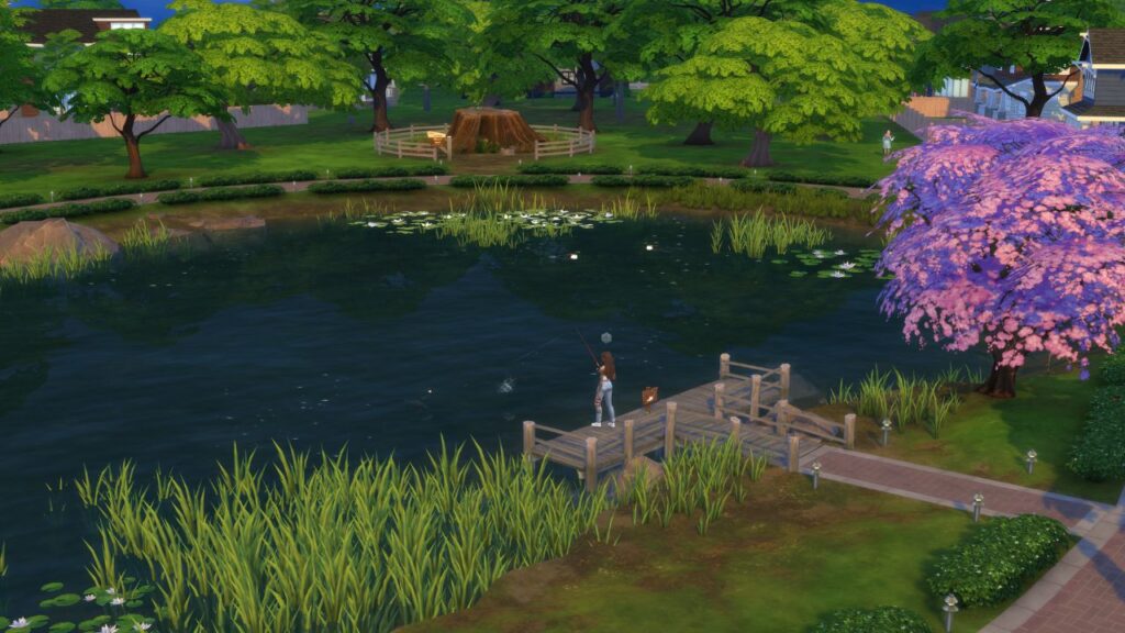 A screenshot from The Sims 4 showing a sim fishing on a wooden dock in a large pond