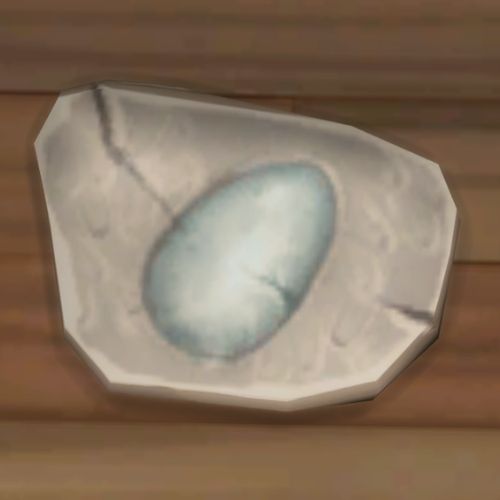 A screenshot from The Sims 4 showing a rock on the ground. On the rock is an image of an egg