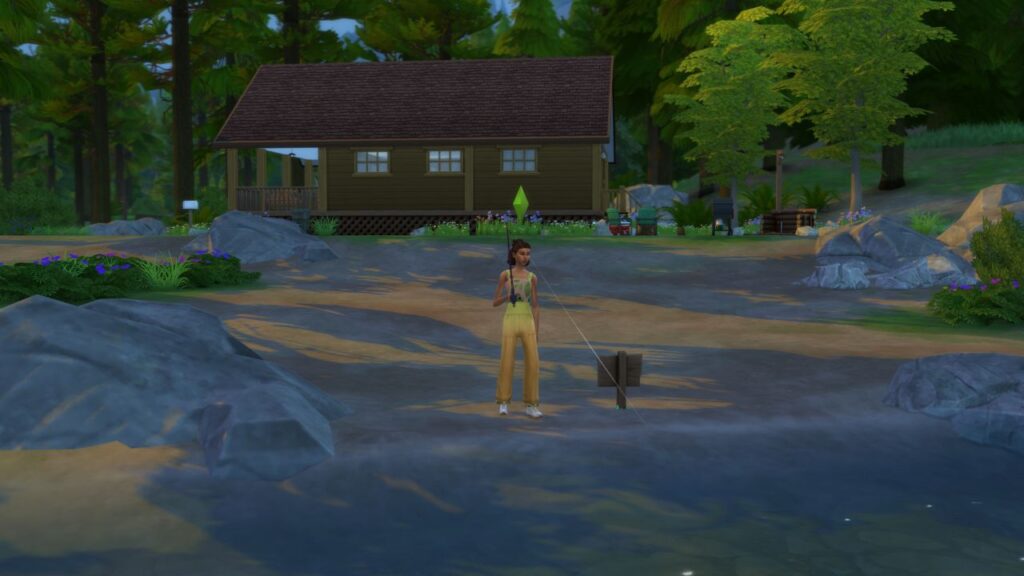 A screenshot from The Sims 4 showing a sim in a yellow outfit fishing next to a cabin