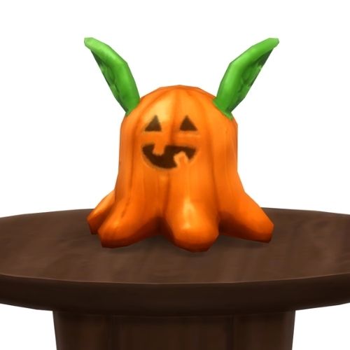A screenshot from The Sims 4 showing a round, brown table with a Meduso Plushie on top that's dressed like a pumpkin