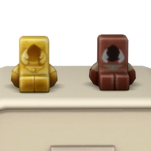 A screenshot from the sims 4 the top of a table with two Simmies on top. The one is gold and the other is a regular Medieval Grim Simmi