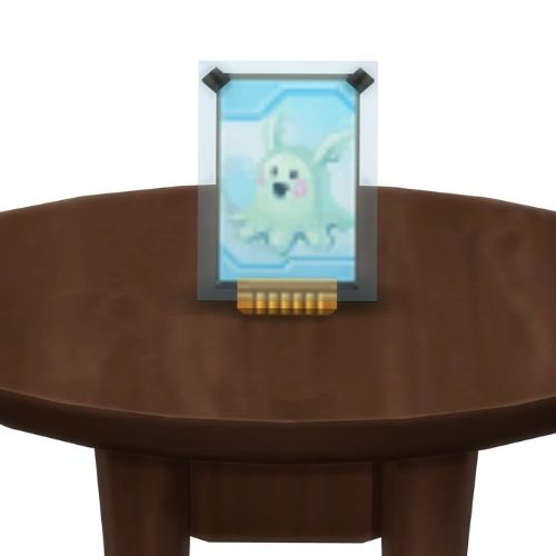 A screenshot from The Sims 4 showing a brown table with a Voidcritter on top. This has the voidcritter named meduso