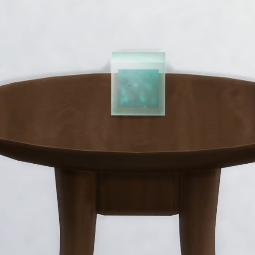 A screenshot from The Sims 4 showing a dark brown table with a Melacoo in a square on top