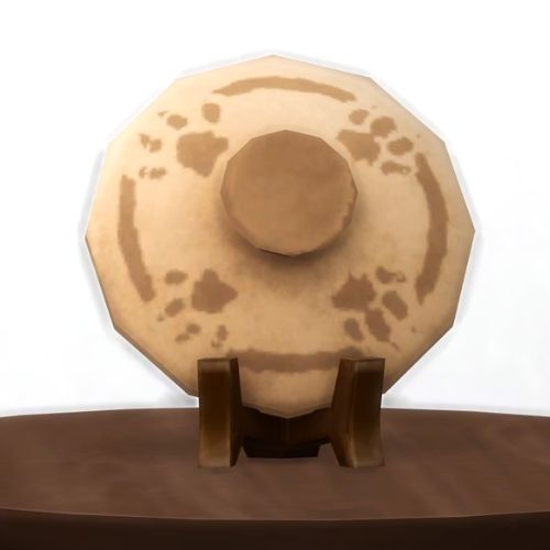 A screenshot from The Sims 4 showing a brown wood table and on top is a lid from a ceramic pot with paw prints painted on it