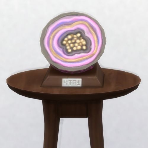 A screenshot from The Sims 4 with a brown table and on top is the geode named Mylom's Tonic