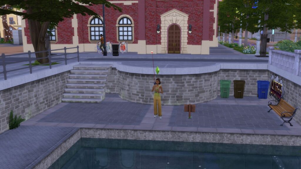 A screenshot from The Sims 4 showing a sim fishing into a canal with garbage bins and a bench near them