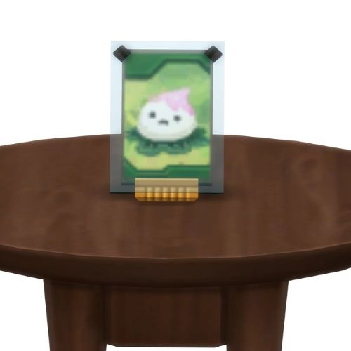 A screenshot from The Sims 4 showing a brown table with a Voidcritter on top. This has the voidcritter named nymphaea