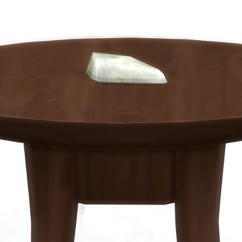A screenshot from The Sims 4 showing a brown wooden table with Obtanium on top