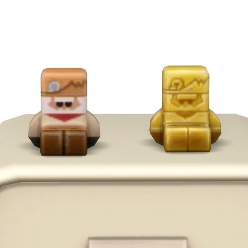 A screenshot from the sims 4 the top of a table with two Simmies on top. The one is gold and the other is a regular Ol' Gabby Simmie