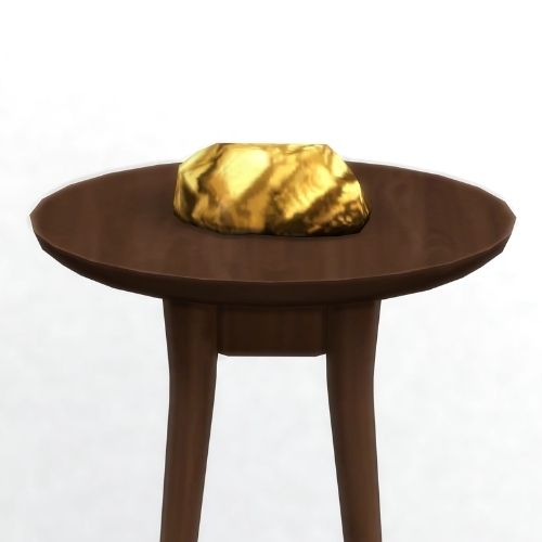 A screenshot from The Sims 4 showing a brown wooden table with Ozinold on top
