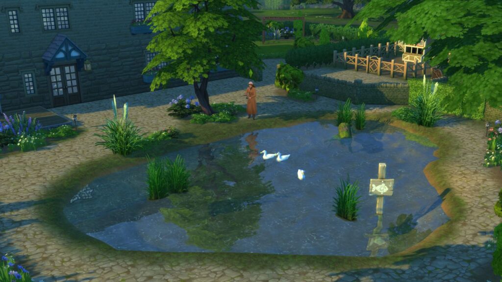 A screenshot from The Sims 4 showing a pond to fish in located in the backyard of the watson family