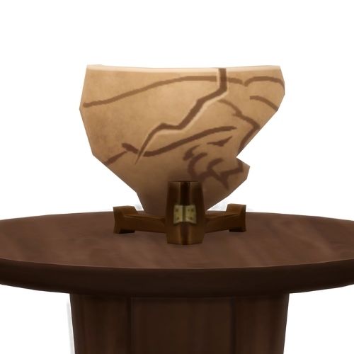 A screenshot from The Sims 4 showing a brown wood table and on top is a shard of a ceramic pot with an animal body painted on it