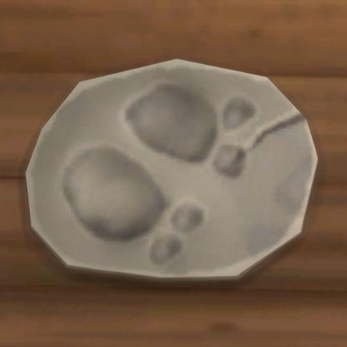 A screenshot from The Sims 4 showing a rock on the ground. On the rock is an image of a set of hoof prints