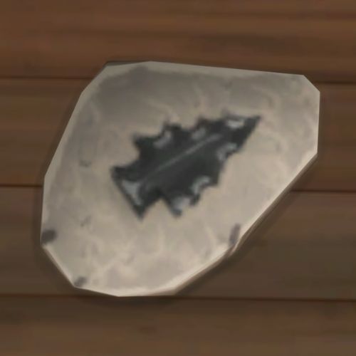 A screenshot from The Sims 4 showing a rock on the ground. On the rock is an image of a pointy Christmas tree shape