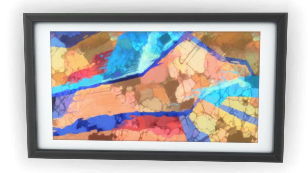 A screenshot from The Sims 4 of a black frame with an image of a colourful rock under a microscope 