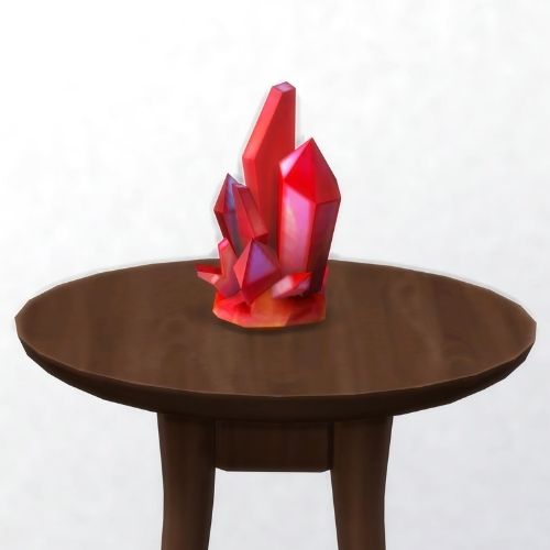 A screenshot from The Sims 4 showing a brown circular table with a crystal on top. This image has a crystal called rainborz