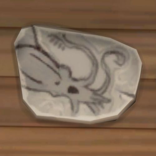 A screenshot from The Sims 4 showing a rock on the ground. On the rock is an image of a sea monster