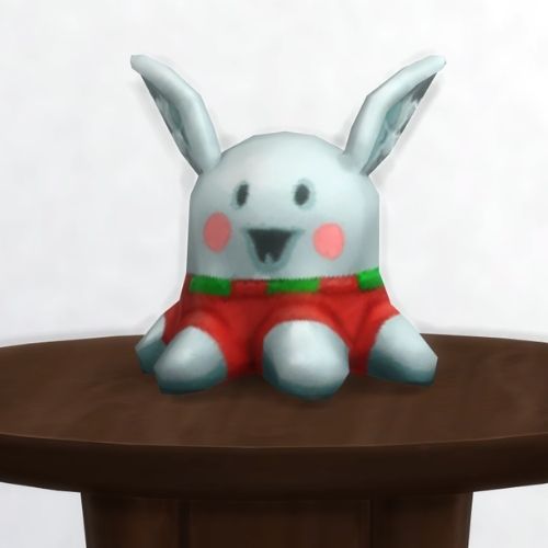 A screenshot from The Sims 4 showing a round, brown table with a Meduso Plushie on top that's wearing a Christmas sweater