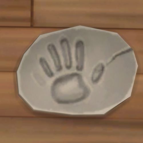 A screenshot from The Sims 4 showing a rock on the ground. On the rock is an image of a hand print