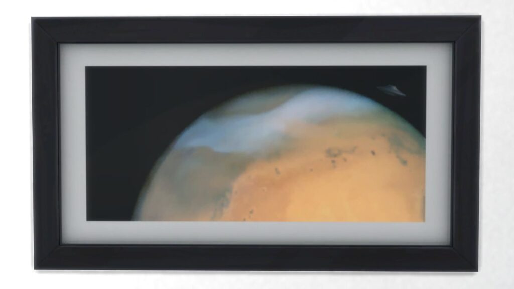 A screenshot from The Sims 4 showing a black frame with a print of the moon up close