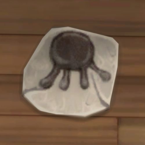 A screenshot from The Sims 4 showing a rock on the ground. On the rock is an image of a an udder