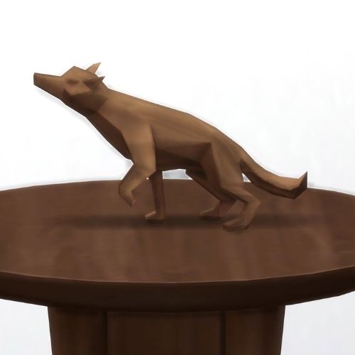 A screenshot from The Sims 4 showing a brown wood table and on top is a wooden dog