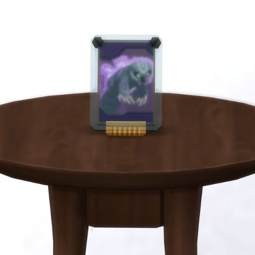 A screenshot from The Sims 4 showing a brown table with a Voidcritter on top. This has the voidcritter named wickyn