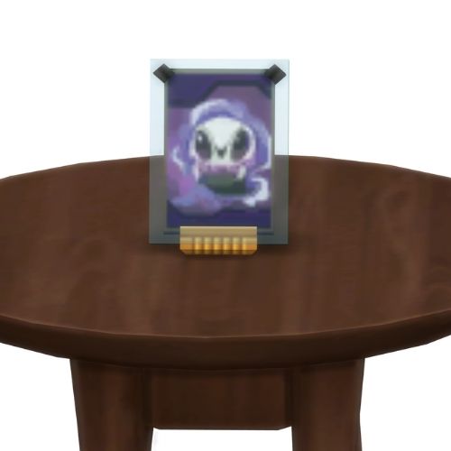 A screenshot from The Sims 4 showing a brown table with a Voidcritter on top. This has the voidcritter named wisp