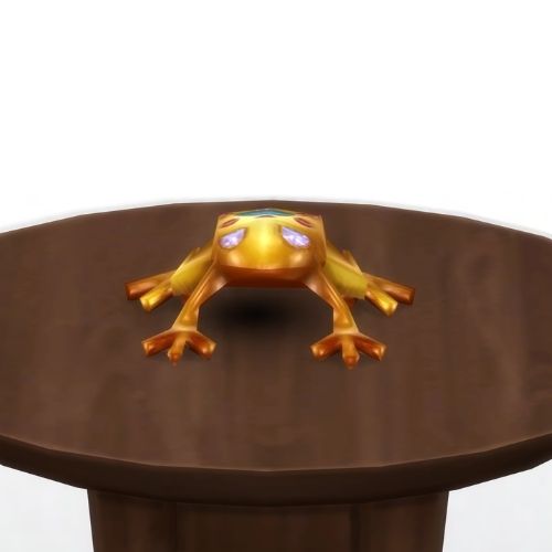 A screenshot from The Sims 4 showing a brown circle table and on top is a golden frog with purple eyes