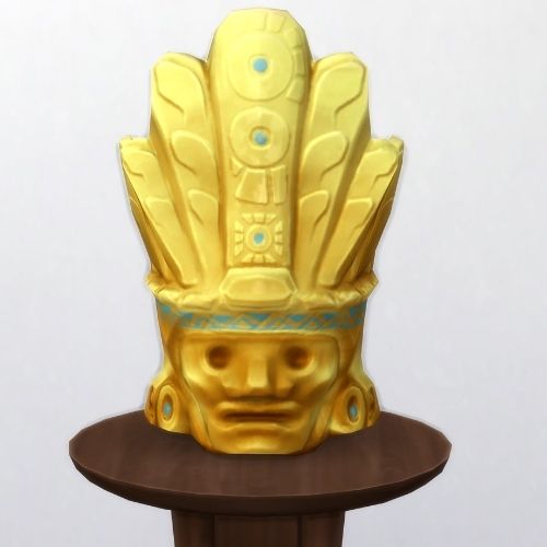 A screenshot from The Sims 4 showing a brown circle table and on top is a golden mask with blue designs