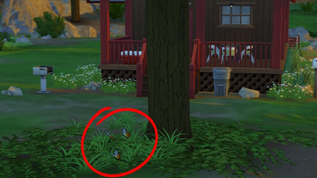A screenshot from The Sims 4 showing three Jezebel butterflies flying beside a tree in front of a red and brown building