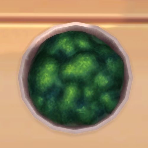 A screenshot from The Sims 4 showing a bowl on a wooden floor. Inside the bowl is moss