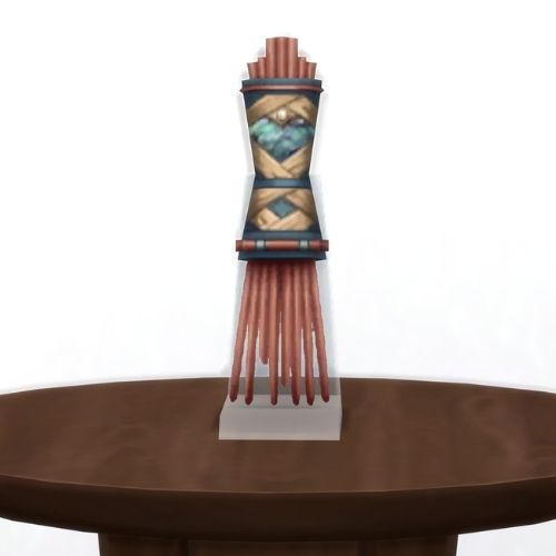 A screenshot from The Sims 4 showing a brown table with The Fingers of Sulani in copper 